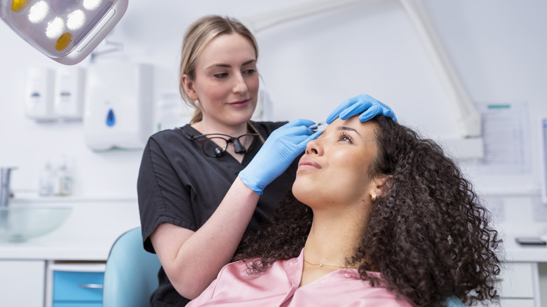 Woman laying down getting lip injections