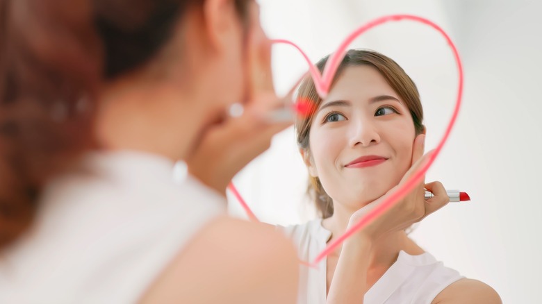 woman lipstick heart on mirror