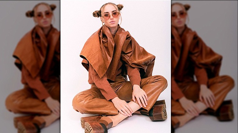 Model in brown leather capris