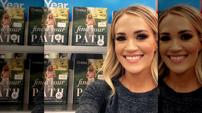 Carrie Underwood posing with her book