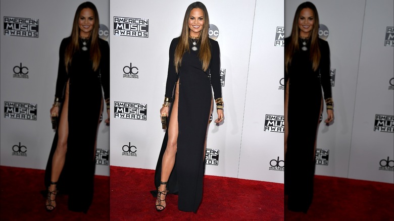 Chrissy Teigen poses for photos on AMAs red carpet