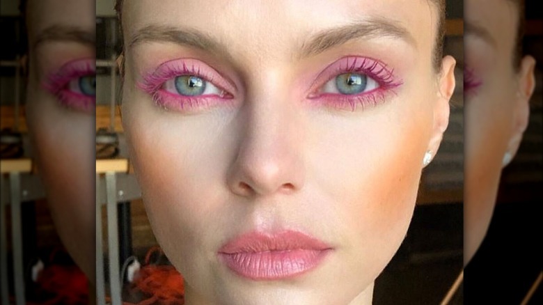 Model wearing pink mascara 