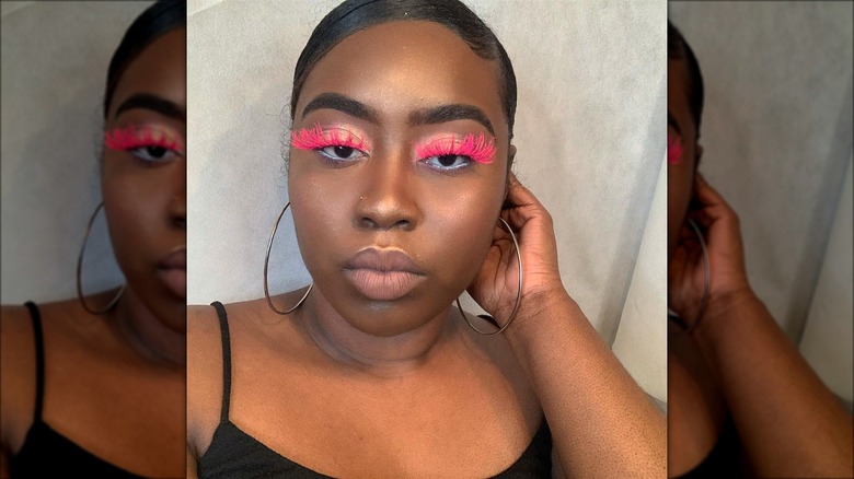 Woman with bright pink lashes