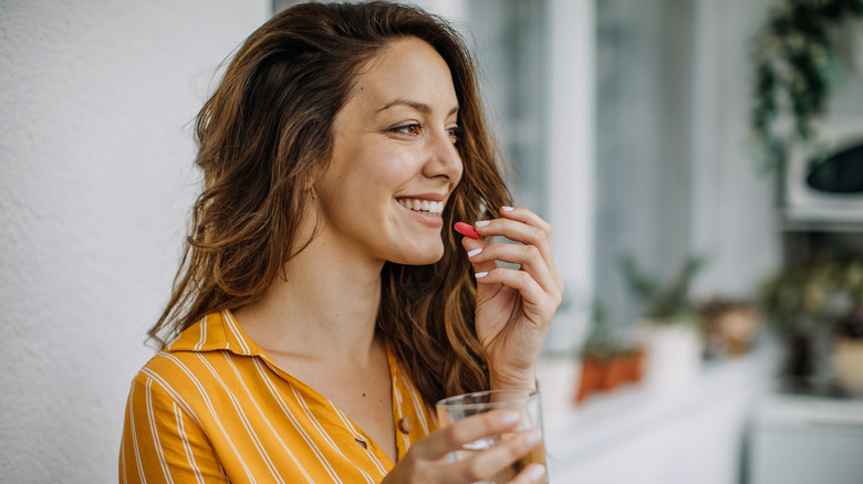 A woman drinking a supplement