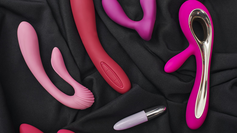 Various sex toys against black fabric