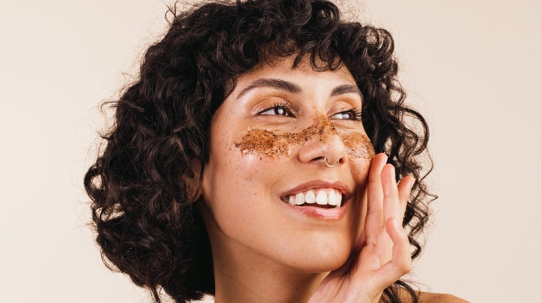 woman using scrub on face