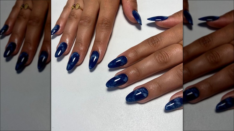 Person with dark blue nails