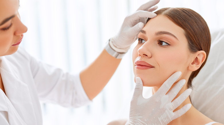 A woman being examined by a dermatologist
