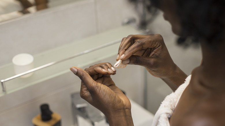 Woman working on her nails 