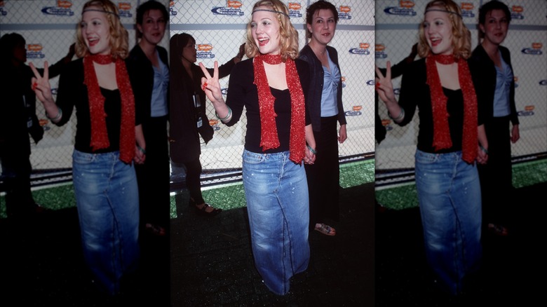 Drew Barrymore on the red carpet in a red scarf and denim maxi skirt