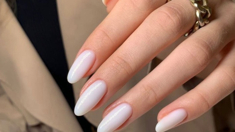 Slightly sheer white nails in almond shape