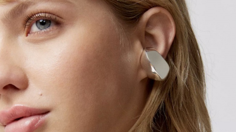 Woman wearing chunky silver ear cuff