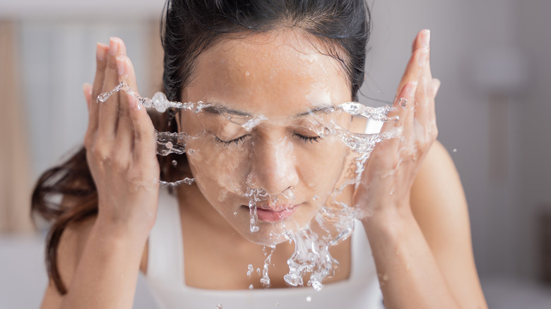 Splashing face with water