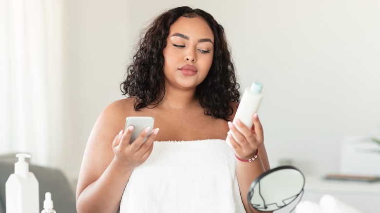 Woman reading skincare product label
