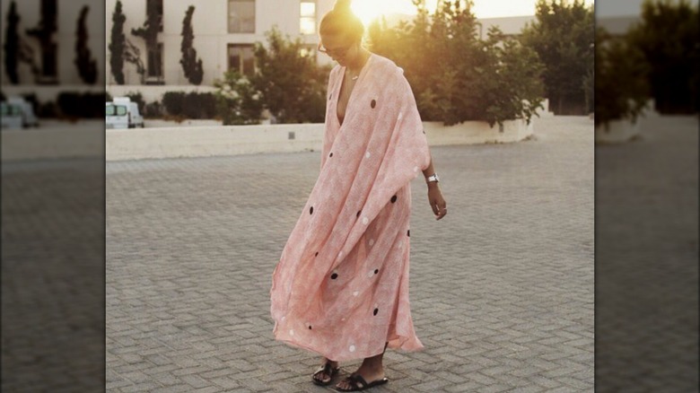 woman wearing caftan and twirling