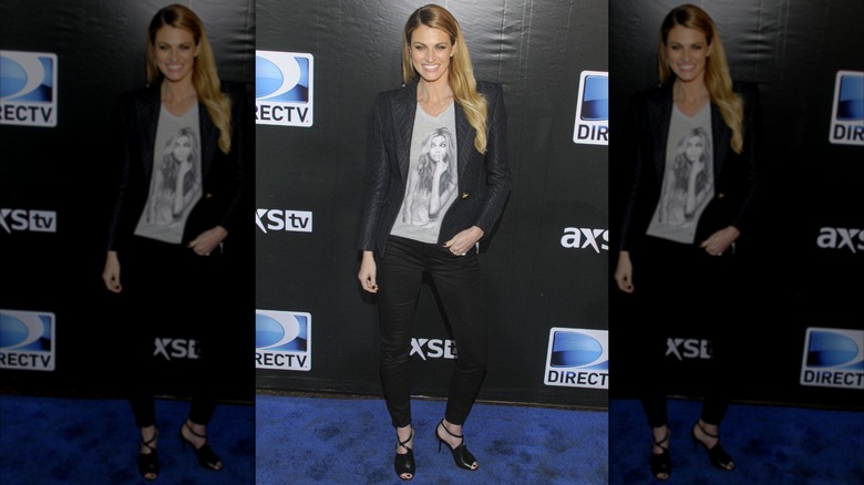 Erin Andrews wearing a graphic tee and blazer at a DirecTV event