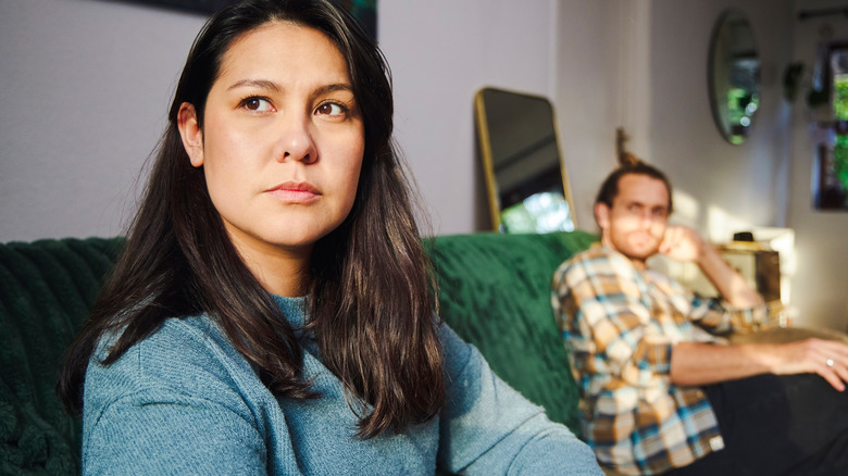Couple not getting along on couch
