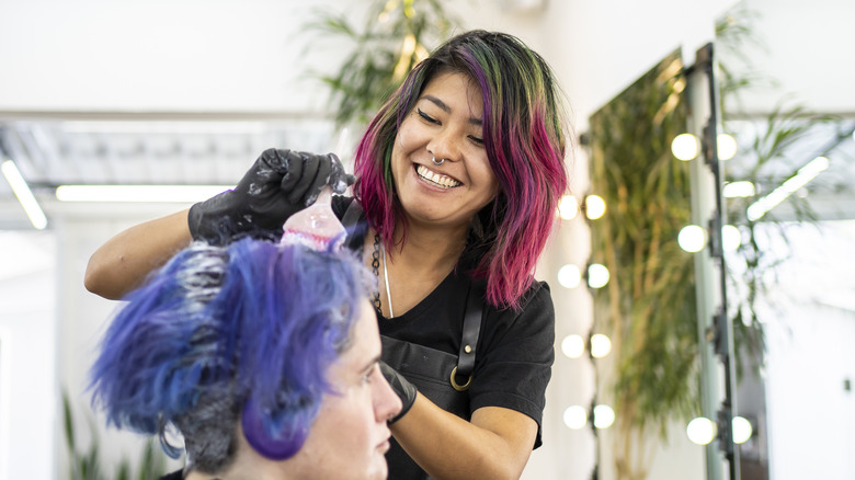 Hairdresser dyeing hair