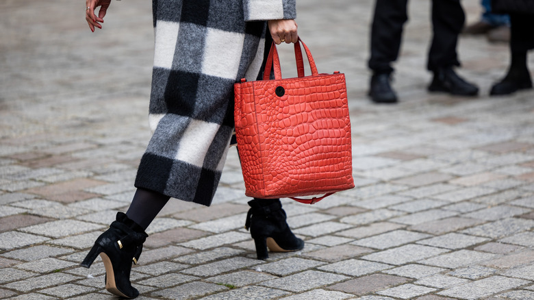 Woman carrying a red bag 