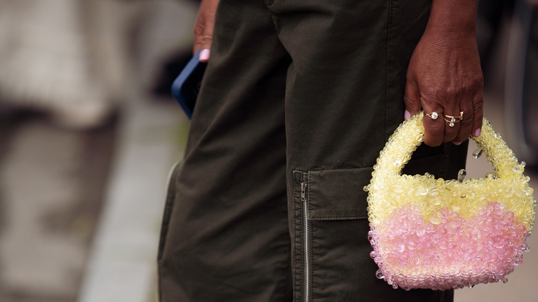Woman carrying pink sequin purse 