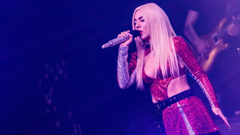 ava max performing in red outfit