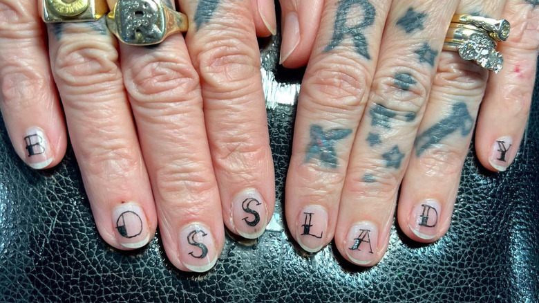 Set of fingernail tattoos that spell out 'Boss Lady'
