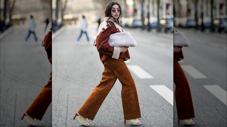 A woman with a fluffy clutch 