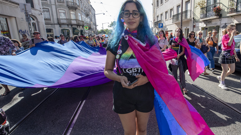 woman wears bisexual pride flag