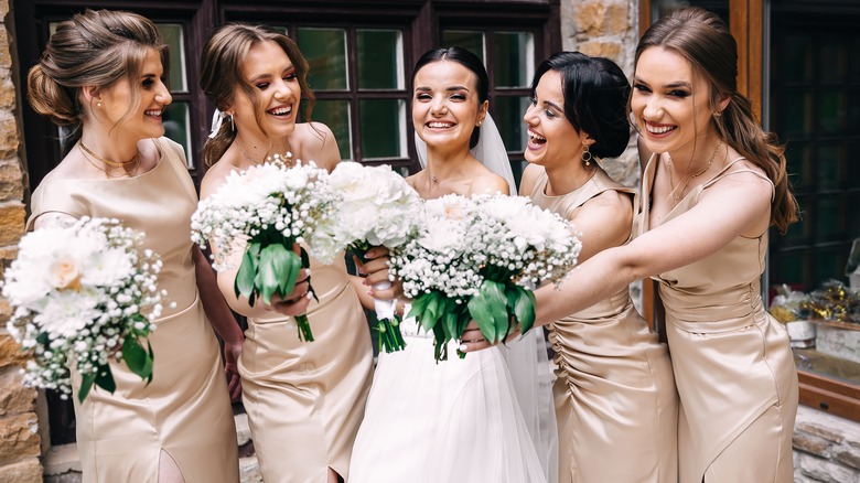 Bride and bridesmaids smiling together