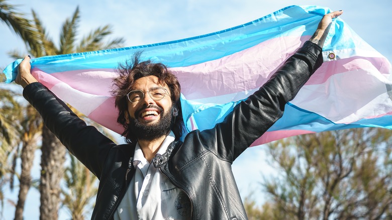 Person with trans rights flag