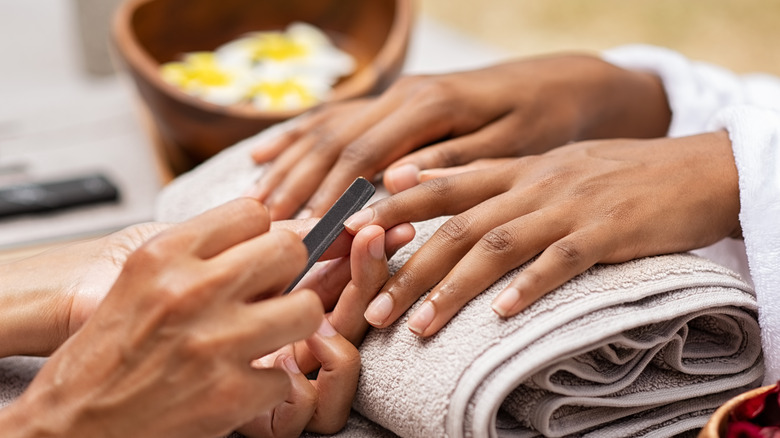 woman getting manicure