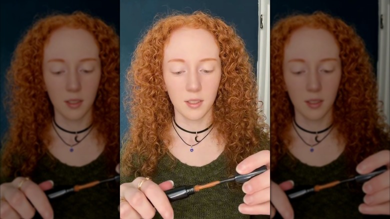 Redheaded woman trying H2BAR mascara