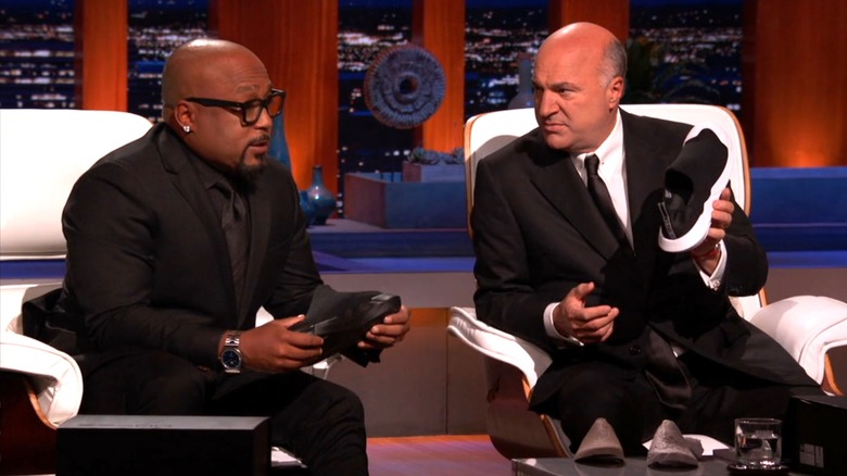 Daymond John and Kevin O'Leary hold Muvez shoes on Shark Tank Season 11