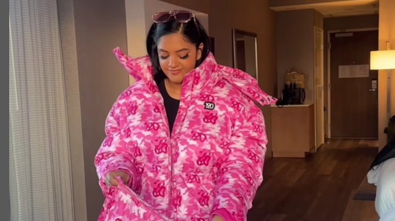 Woman modeling pink camo puffer coat