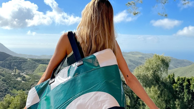 Model wearing green and white Rareform tote