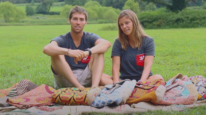 Jack DuFour and Alley DuFour sitting in a field alongside Taaluma Totes bags