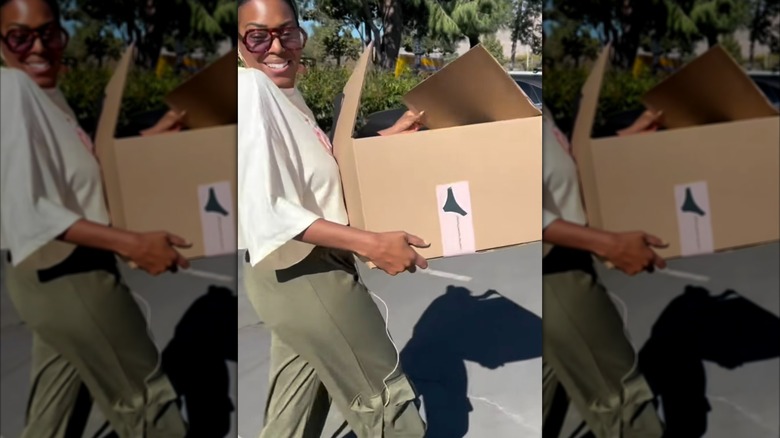 Ashlee Turner carries a box of The Pocket Panty to donate