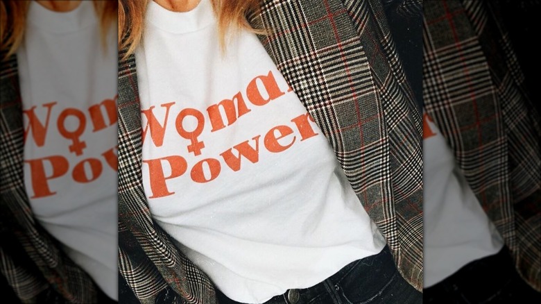 A woman in a Woman Power T-shirt