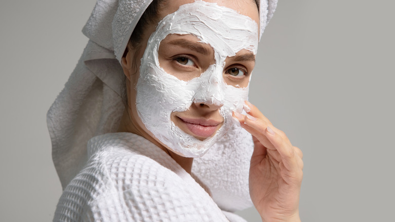 skincare mask and towel on head