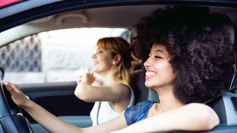 two women smiling in car