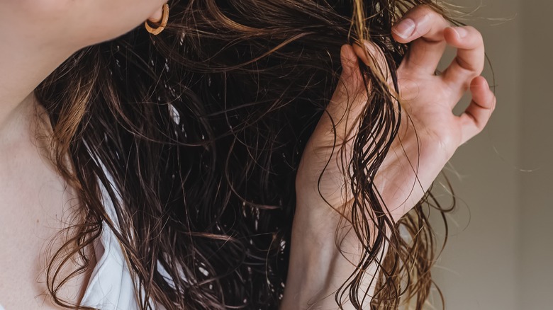 Woman holding wet hair