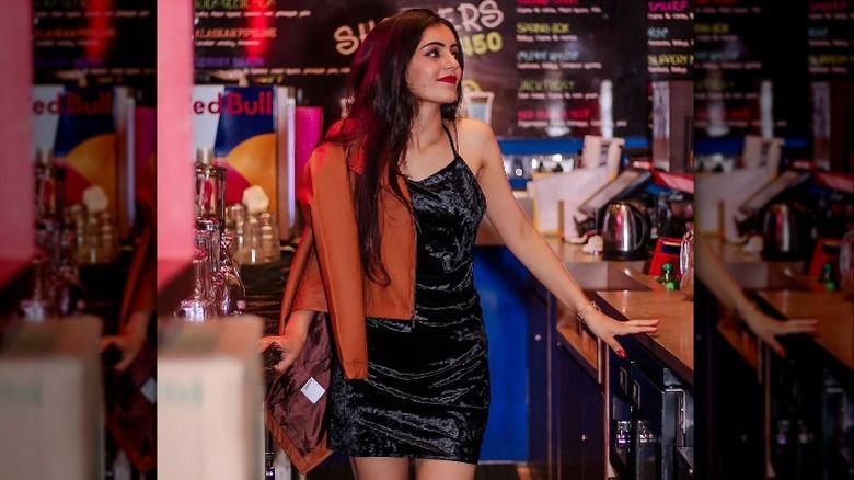 woman in black dress at a bar