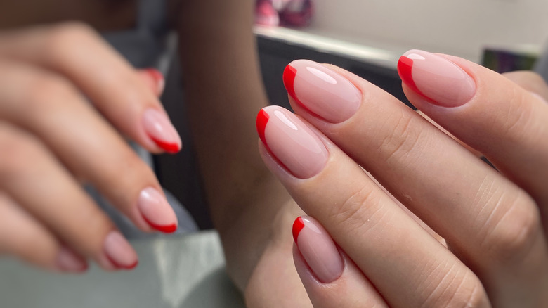 Gel manicure with red half-tips