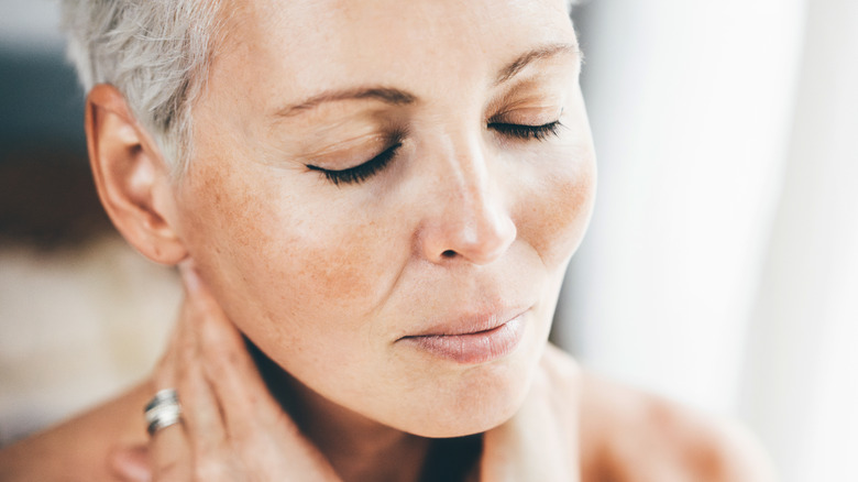 Mature woman with eyes closed and glowing skin