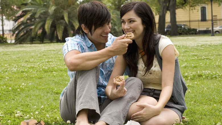 Couple at a park sharing food