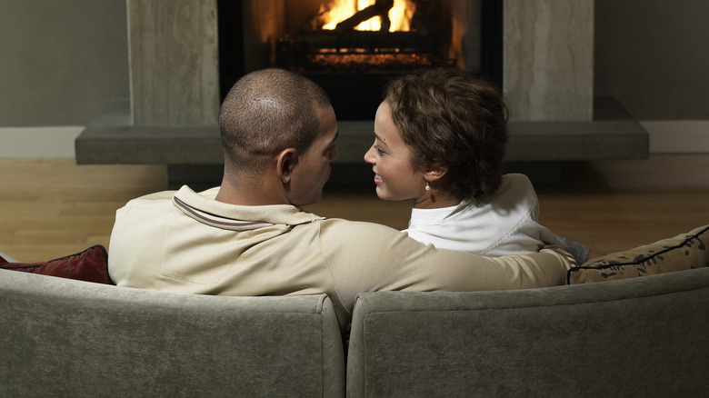 Couple sitting in front of a fire