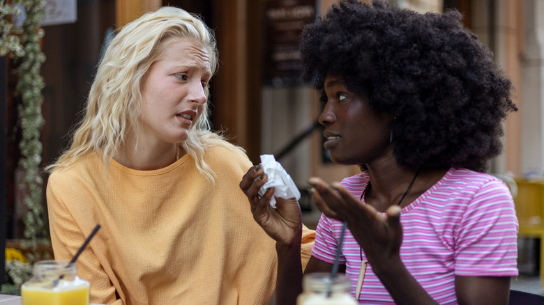 Two women talking intensely