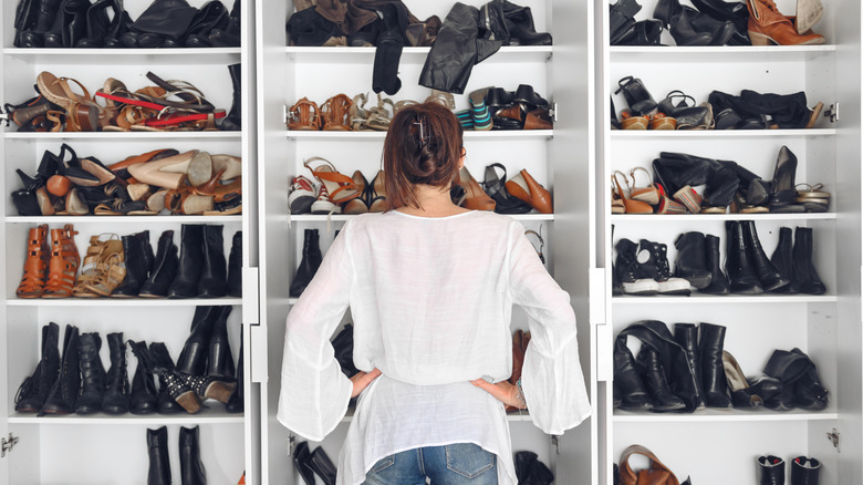 Woman standing in front of a shoe closet
