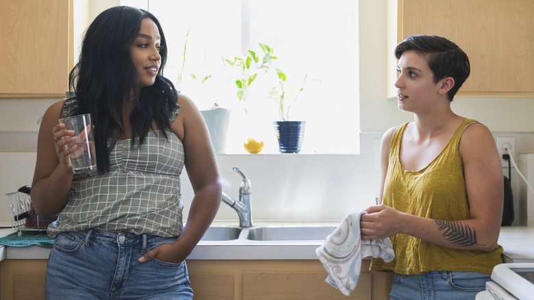 Two women having a conversation in the kitchen