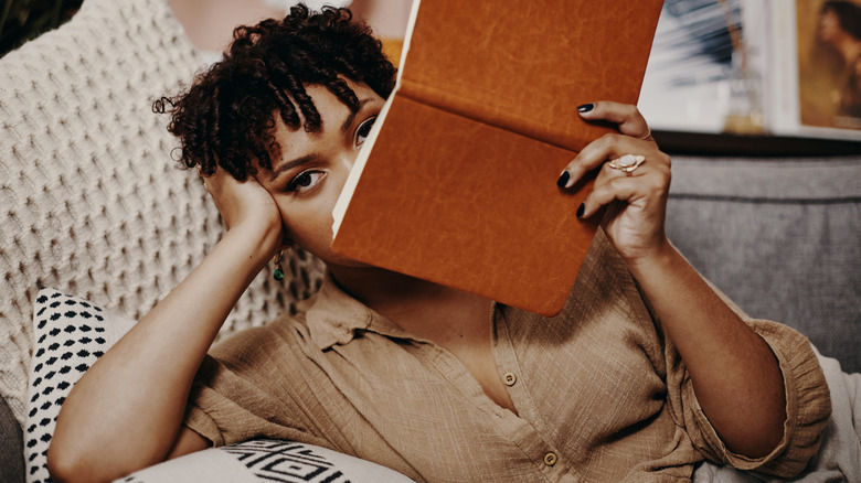 Woman holding a journal to her face